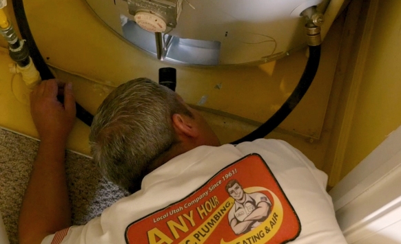 A technician is working on an HVAC unit, measuring with a multimeter, with company logo visible.
