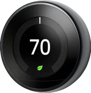 Smart thermostat displaying 70 degrees on a circular, sleek black interface, with a green leaf icon below, symbolizing energy efficiency.