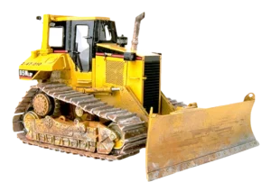 A yellow bulldozer with rugged tracks and a large front blade, displaying signs of rust and wear, conveying a sense of heavy-duty work and durability.