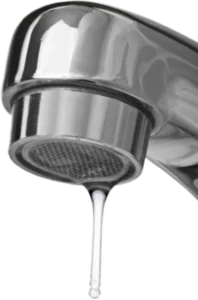 Close-up of a shiny metallic faucet with a single drop of water hanging from the spout.
